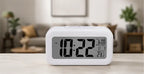 table clock displaying time date and indoor temperature