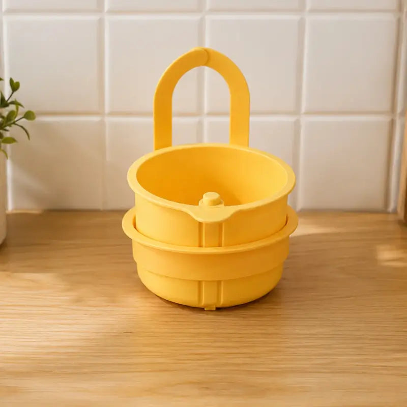 Yellow perforated food strainer for kitchen sink use